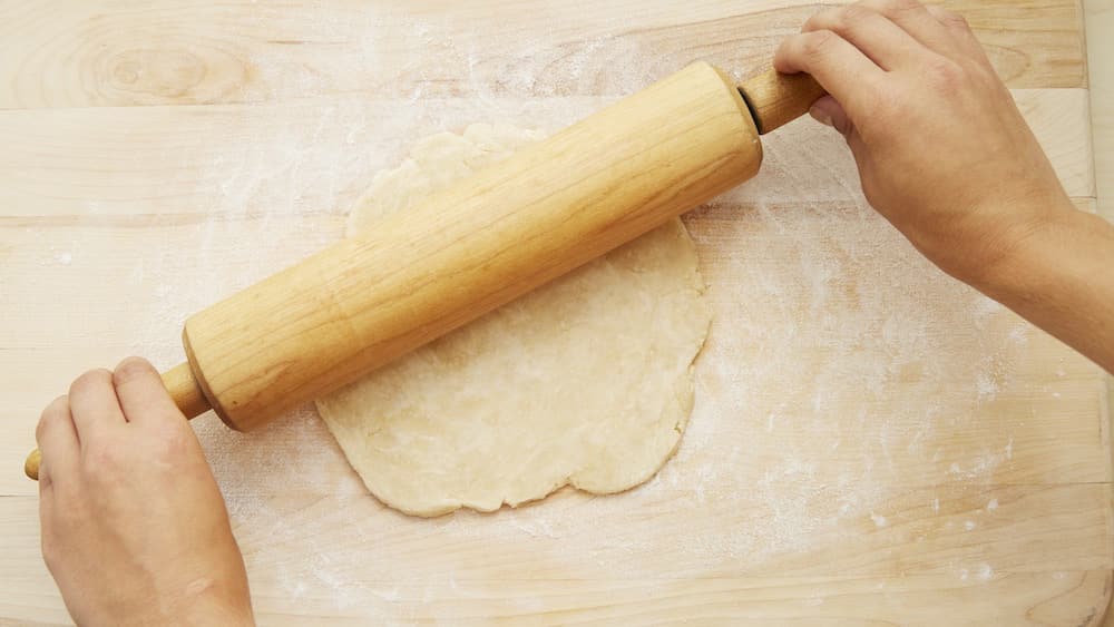 On a lightly floured surface, roll one disc out into an 11-inch circle. 