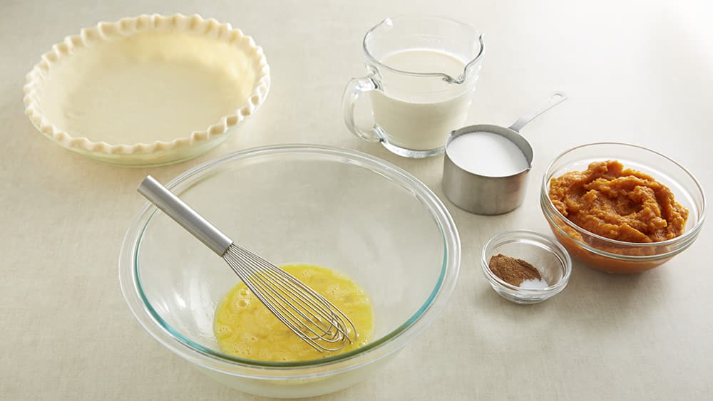 In a large bowl, beat the eggs with a wire whisk. 