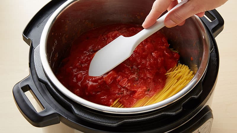 Add the spaghetti noodles evenly over the beef mixture.